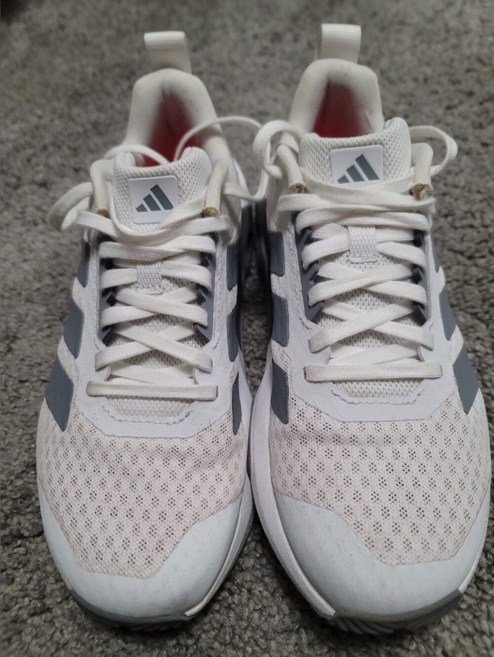 Adidas White Sneakers with Red Insole and Gray Stripes.